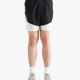 Black pants worn by a person, showing the pants's fit