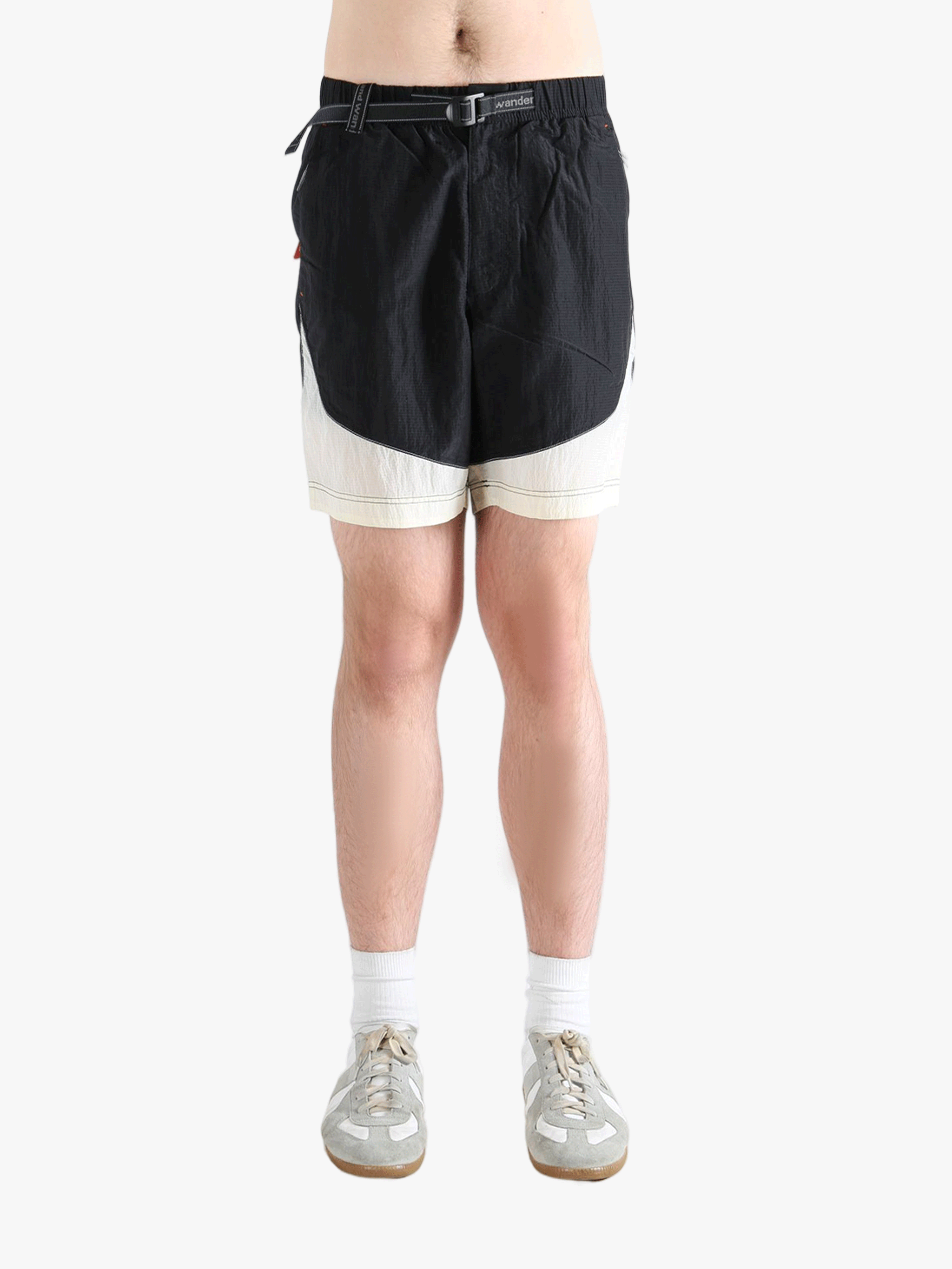 Black pants worn by a person, showing the pants's fit