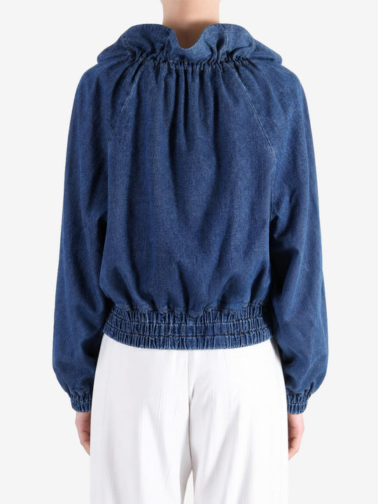 Blue jacket worn by a person, showing the jacket fit