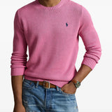 Pink knitwear worn by a person, showing the knitwear fit
