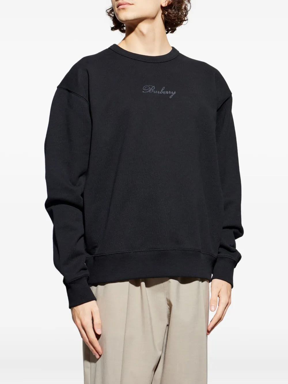 Black sweats worn by a person, showing the sweats' fit