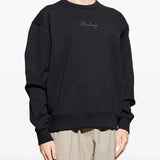 Black sweats worn by a person, showing the sweats' fit