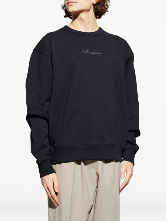 Black sweats worn by a person, showing the sweats' fit