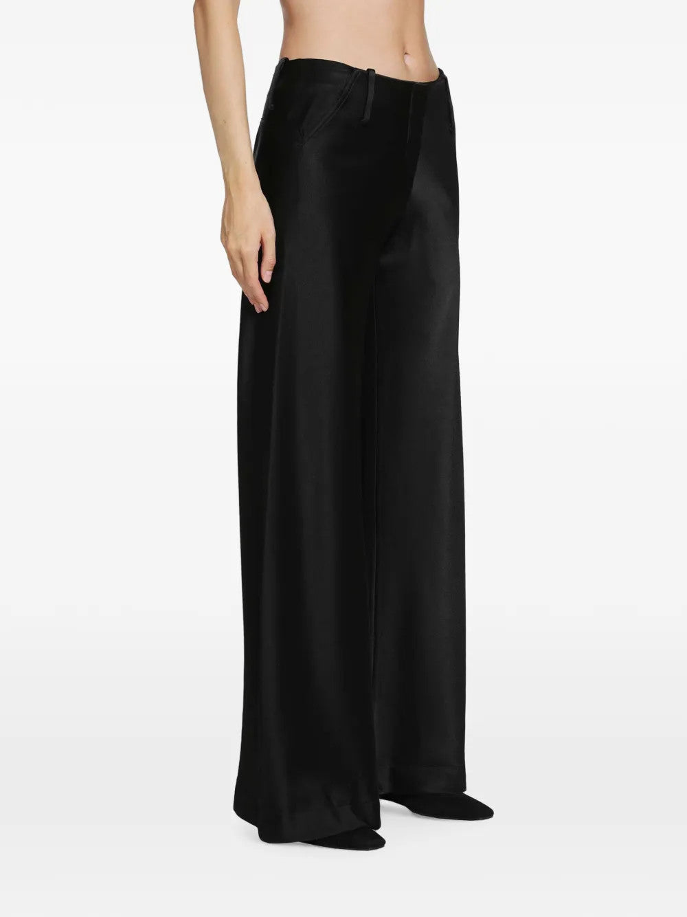Black pants worn by a person, showing the pants fit