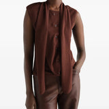 Brown top worn by a person, showing the top fit