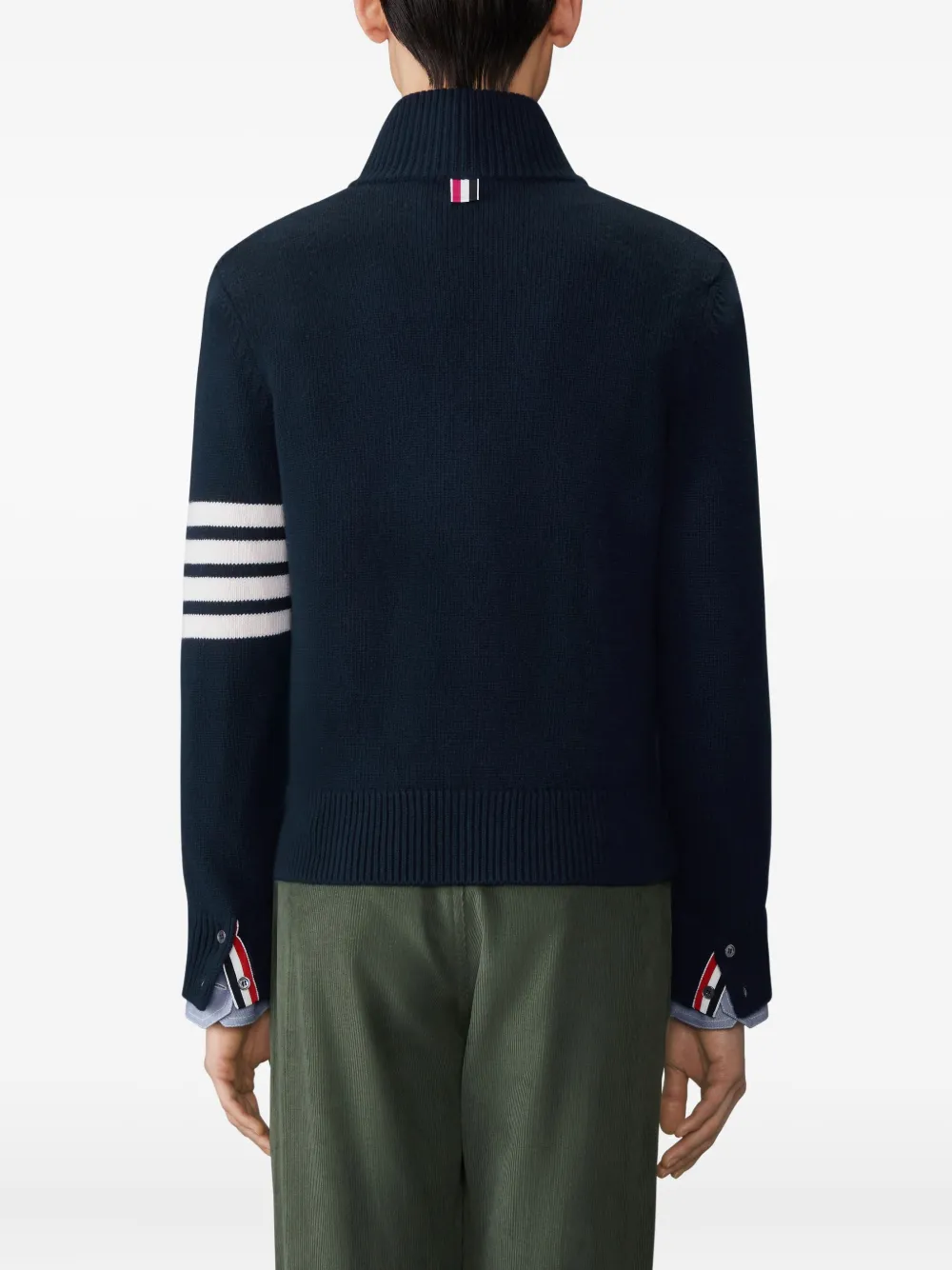 navy knitwear worn by a person, showing the knitwear fit