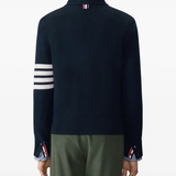 navy knitwear worn by a person, showing the knitwear fit