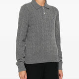 Grey knitwear worn by a person, showing the knitwear's fit