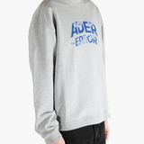 Grey sweater worn by a person, showing the sweater's fit