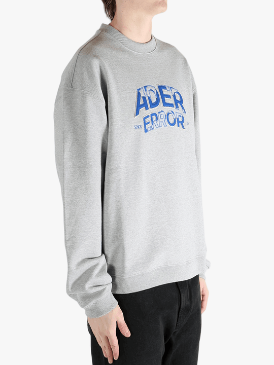 Grey sweater worn by a person, showing the sweater's fit