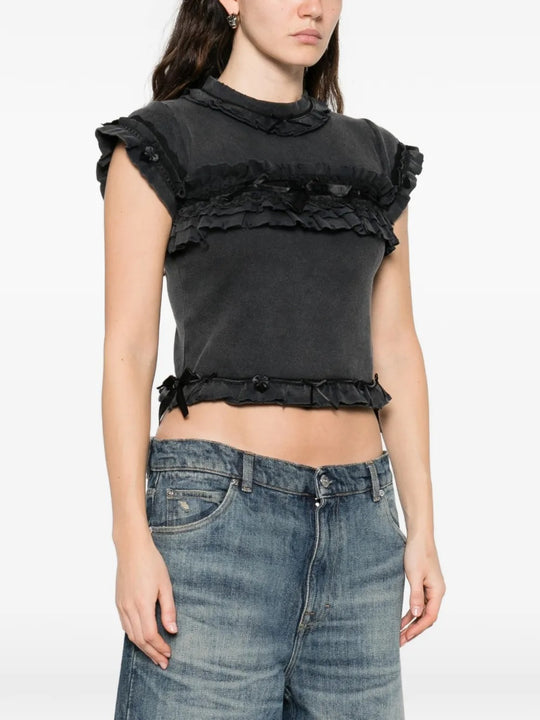 Black t-shirts worn by a person, showing the t-shirts fit