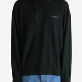 Black hoodie worn by a person, showing the hoodie's fit