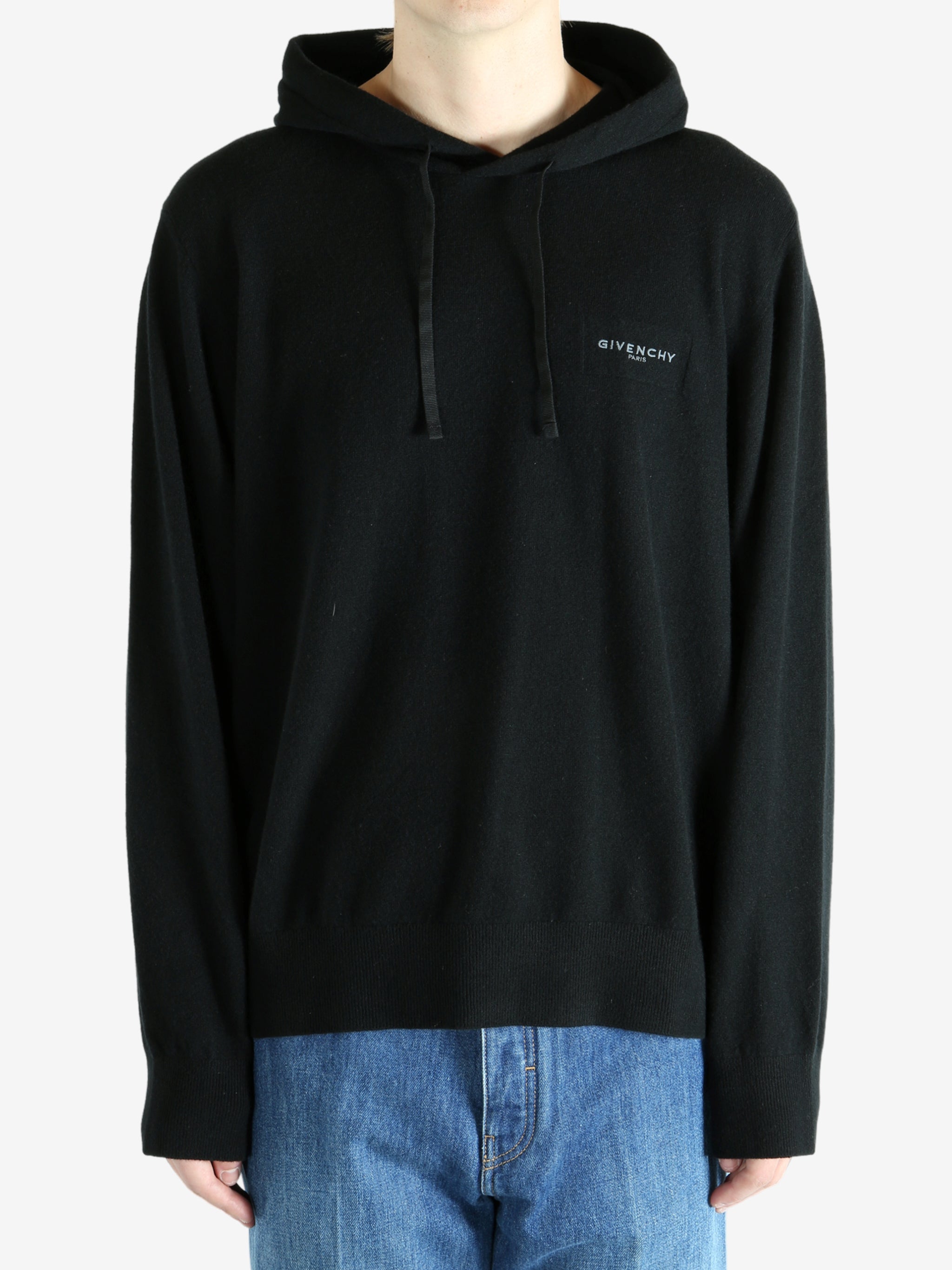Black hoodie worn by a person, showing the hoodie's fit