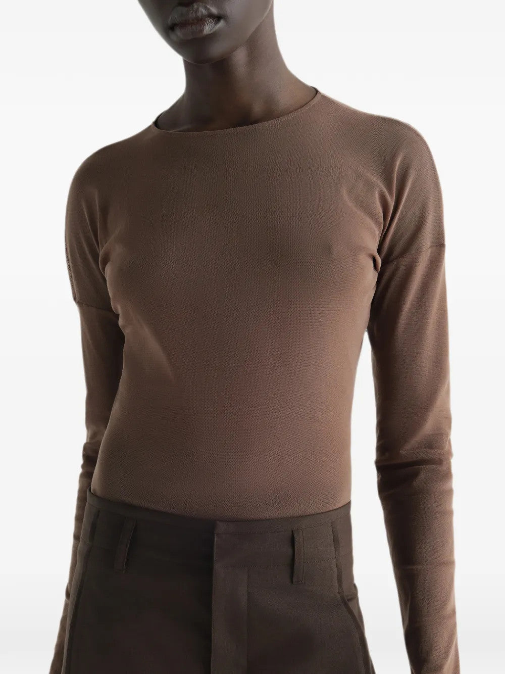 Brown top worn by a person, showing the top fit