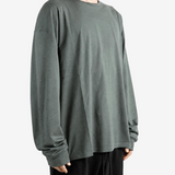 Green t-shirt worn by a person, showing the t-shirt fit