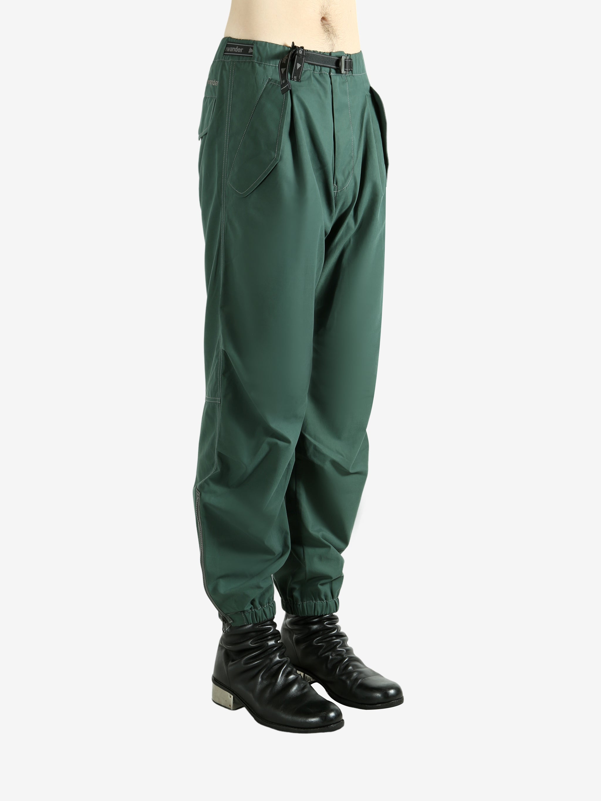 Green pants worn by a person, showing the pants's fit