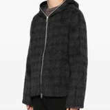 black hoodie worn by a person, showing the hoodie fit