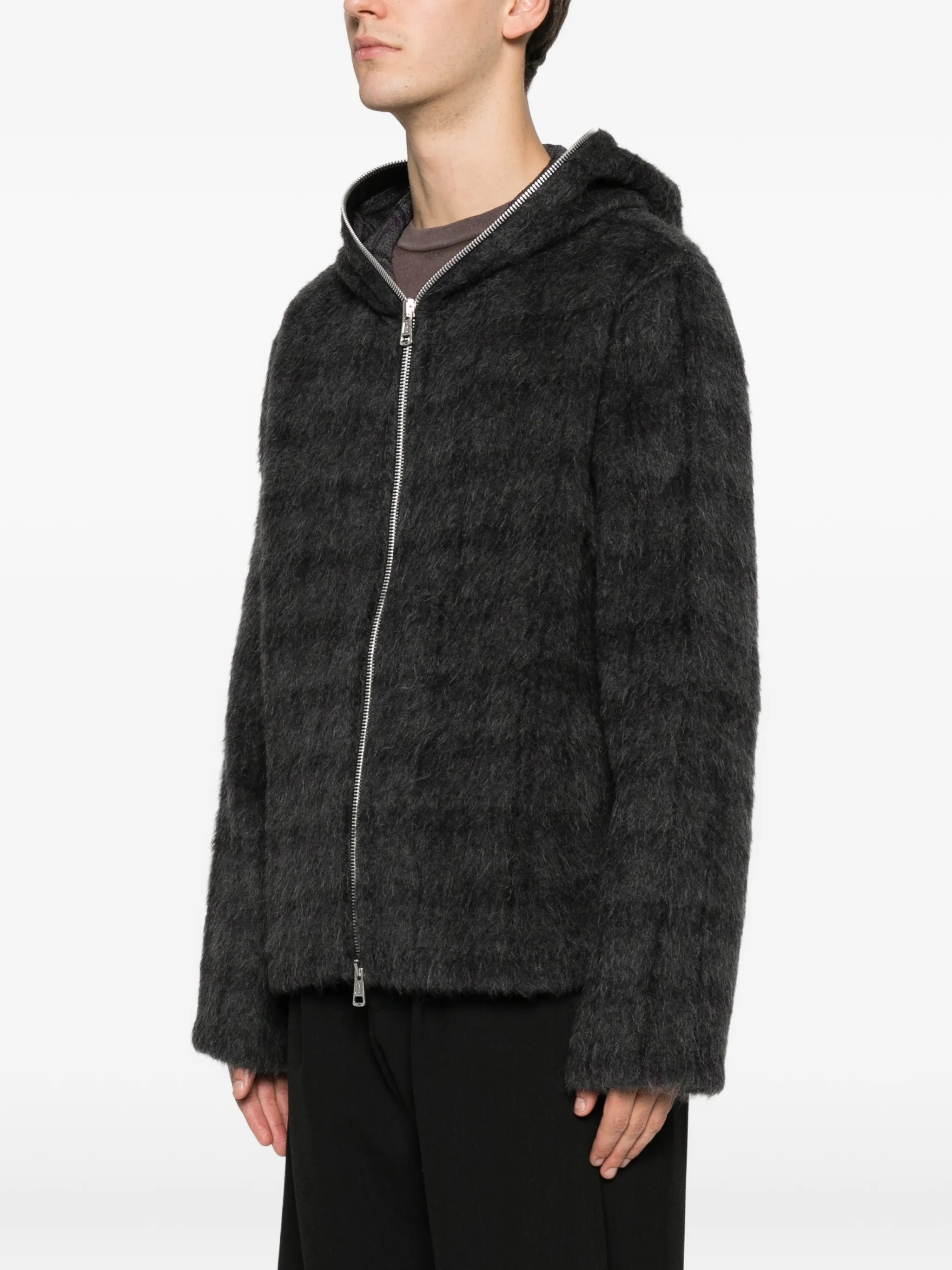 black hoodie worn by a person, showing the hoodie fit