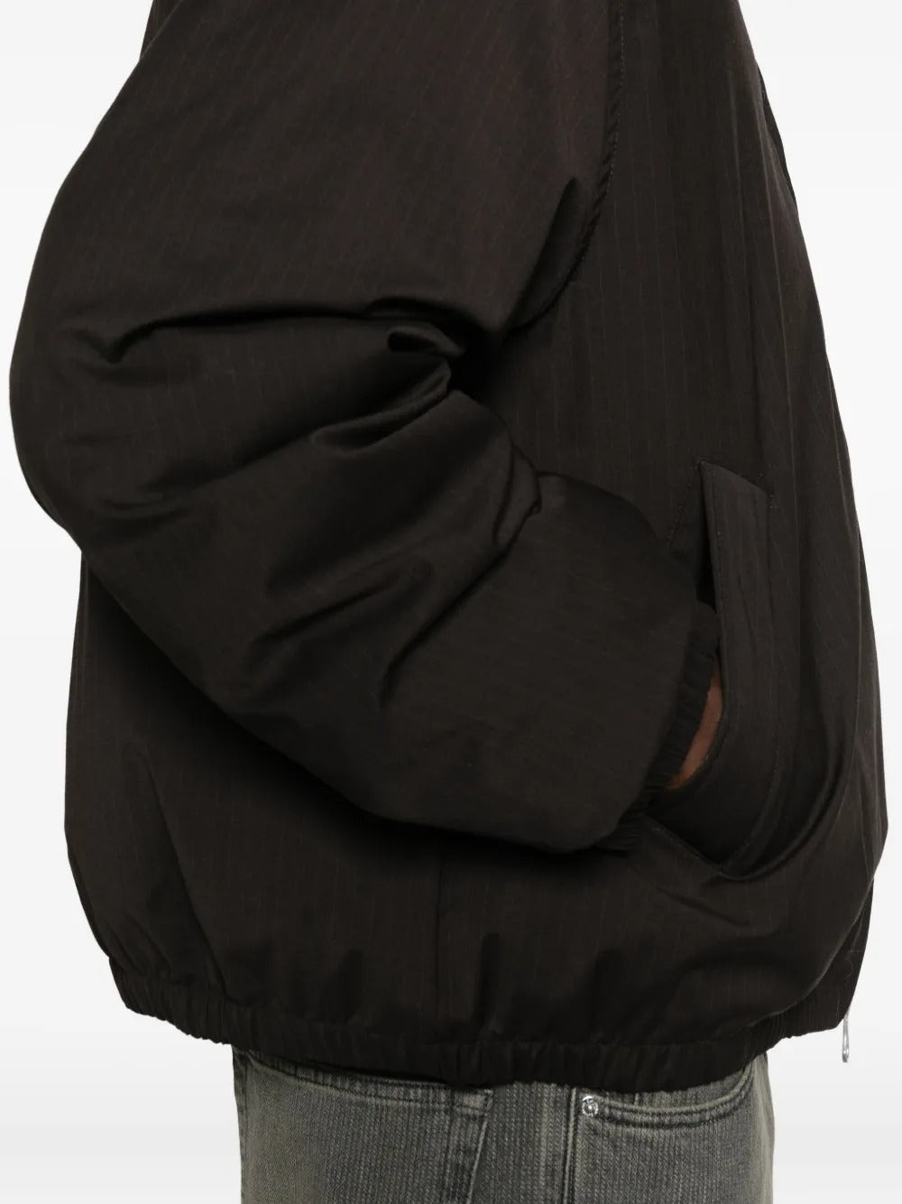 Close up of the brown coat, showing texture of the polyester fabric