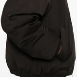 Close up of the brown coat, showing texture of the polyester fabric