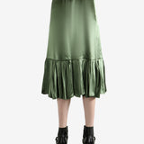 Green skirt worn by a person, showing the  skirt's fit