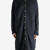 Black coat worn by a person, showing the coat's fit