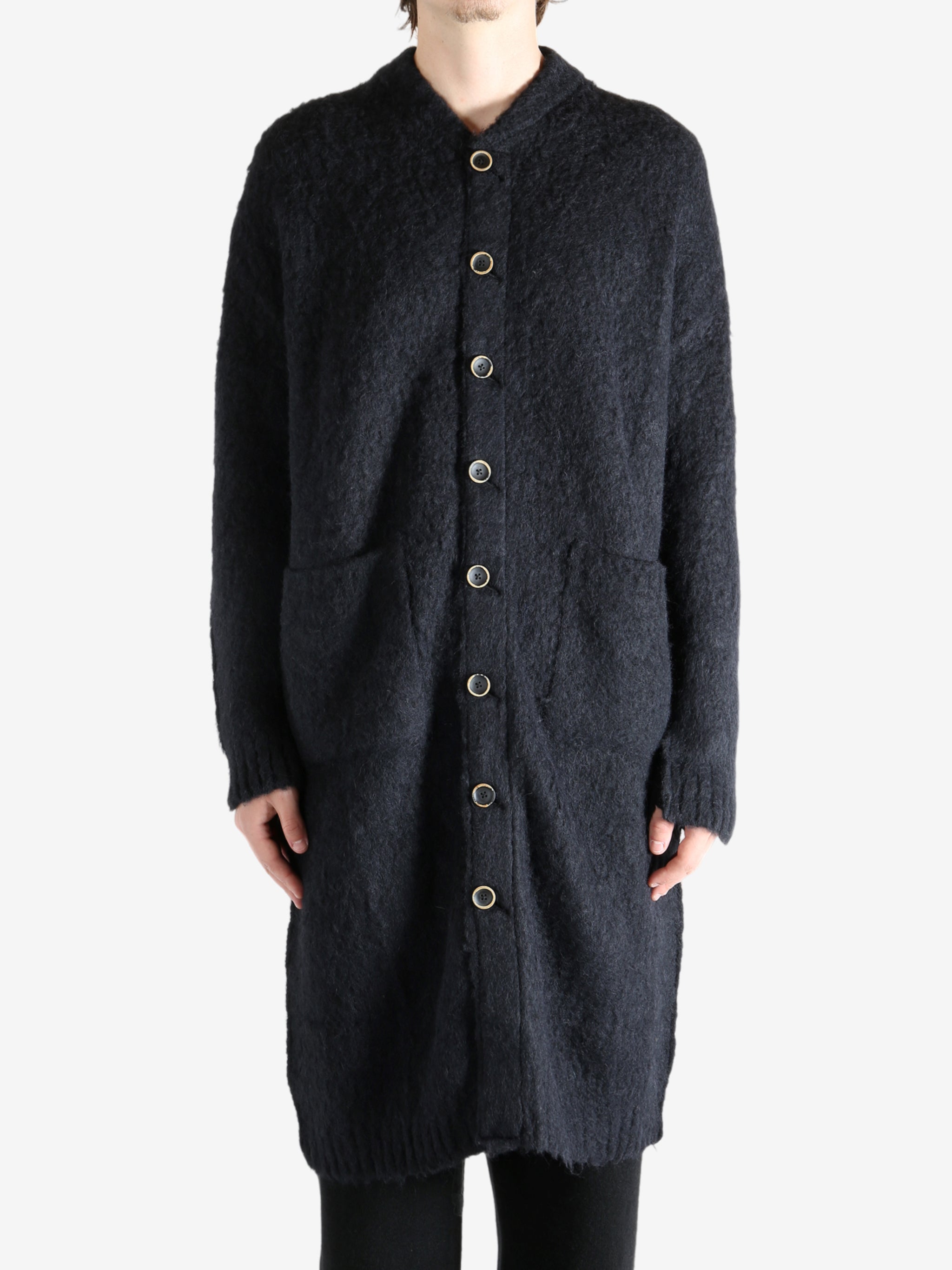 Black coat worn by a person, showing the coat's fit