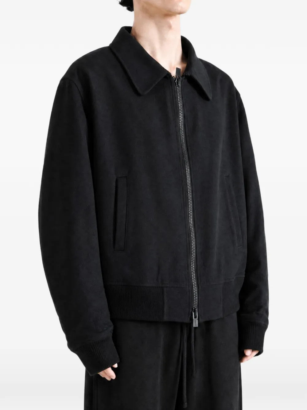 Black jacket worn by a person, showing the jacket fit