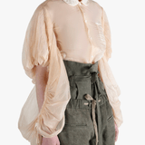 Tan shirt worn by a person, showing the shirt's fit