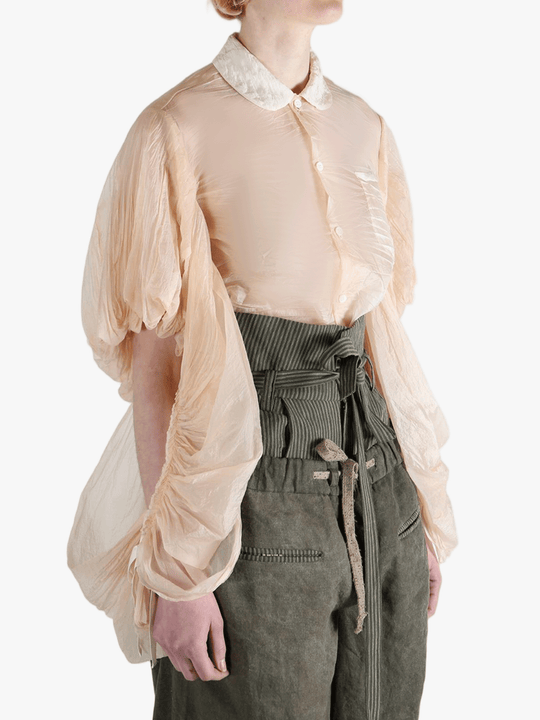 Tan shirt worn by a person, showing the shirt's fit