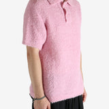 Pink knitwear worn by a person, showing the knitwear's fit