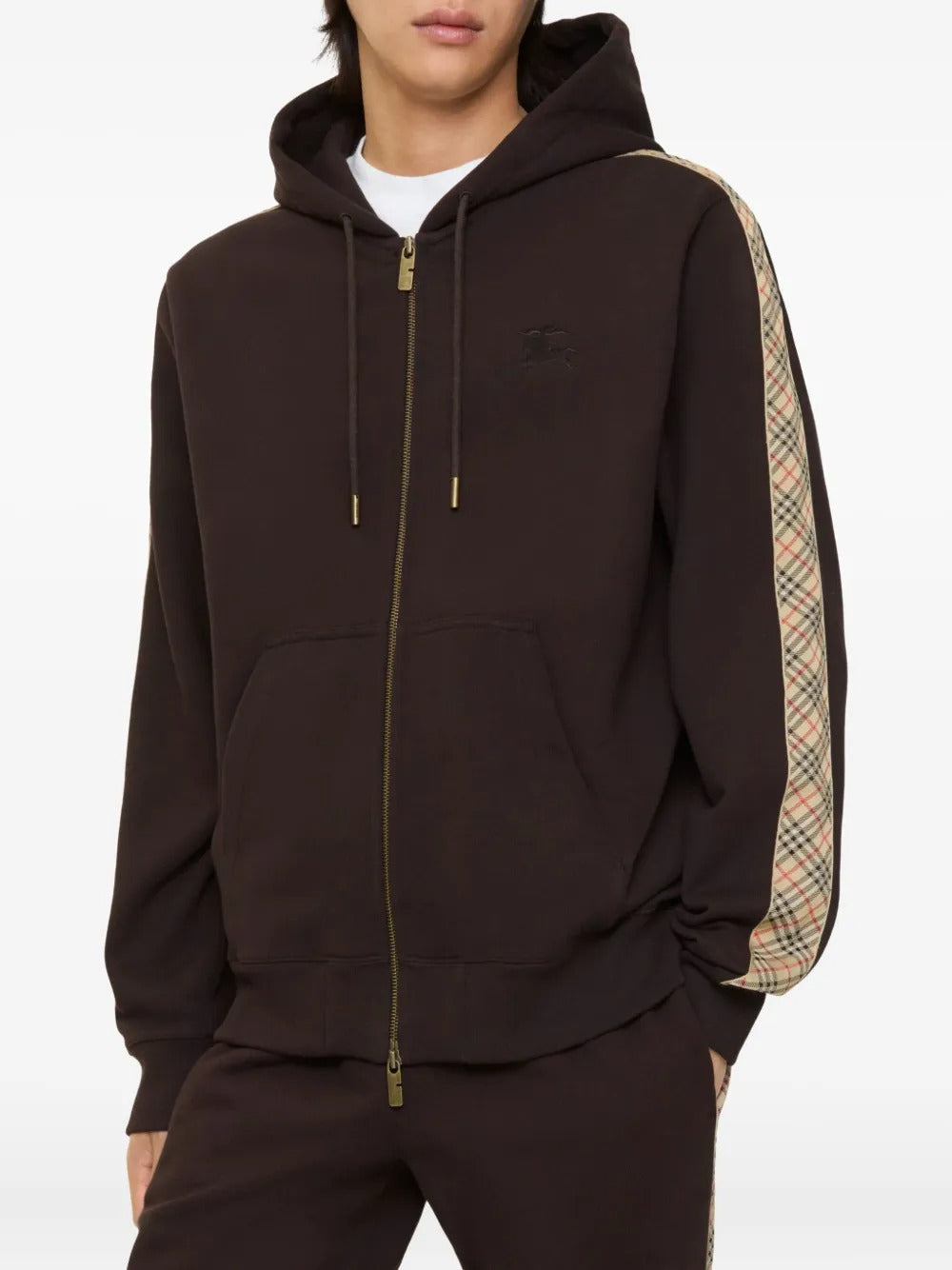 Brown hoodie worn by a person, showing the hoodie's fit