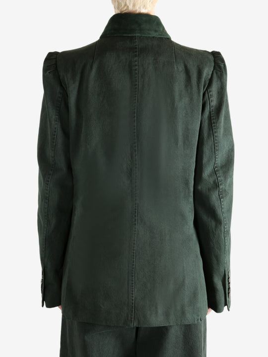 Green jacket worn by a person, showing the jacket's fit