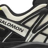 close up of white sneakers, showing texture of the Synthetic  fabric