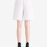 White shorts worn by a person, showing the shorts fit