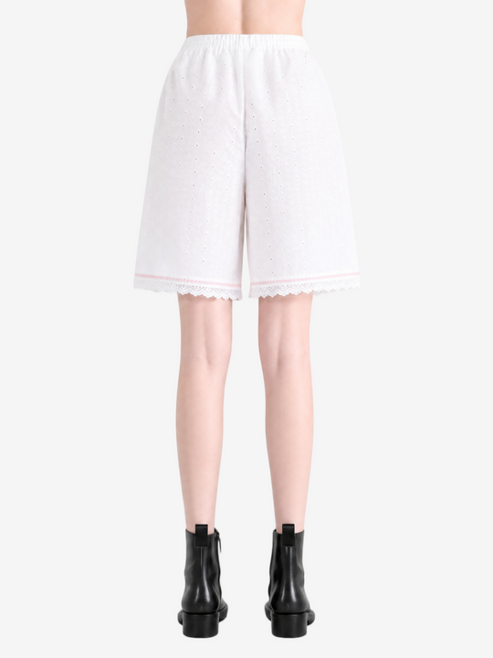 White shorts worn by a person, showing the shorts fit