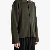 Green knitwear worn by a person, showing the knitwear fit