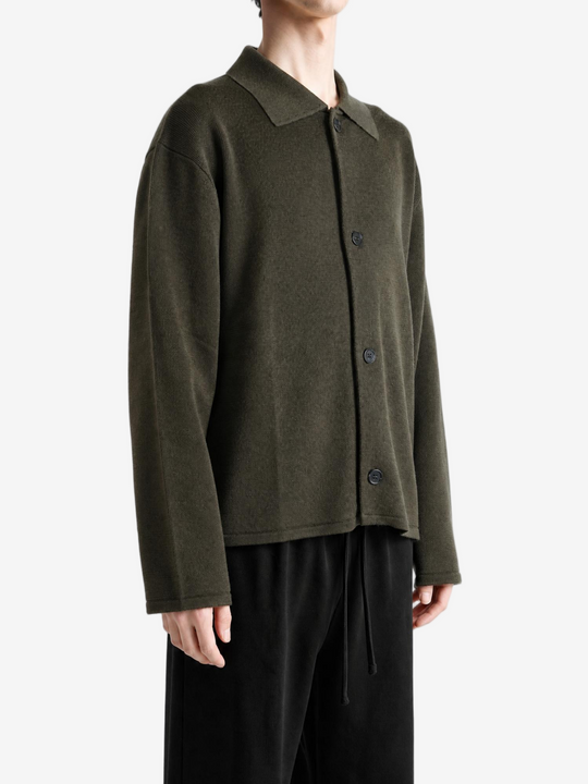 Green knitwear worn by a person, showing the knitwear fit