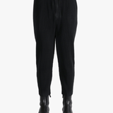 Black pant worn by a person, showing the pants fit