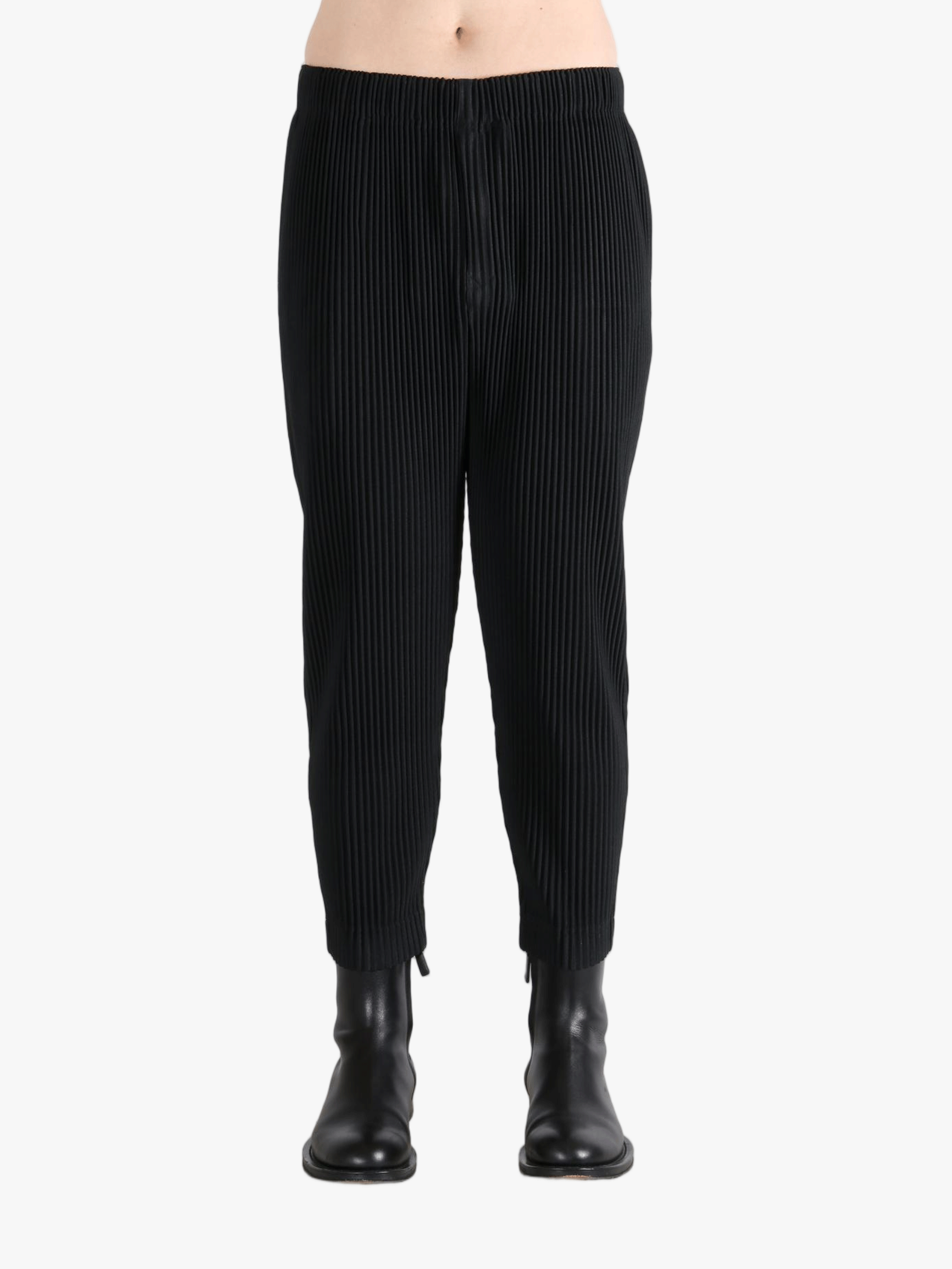 Black pant worn by a person, showing the pants fit