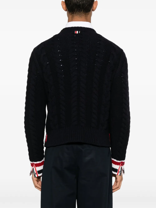 Navy knitwear worn by a person, showing the knitwear fit