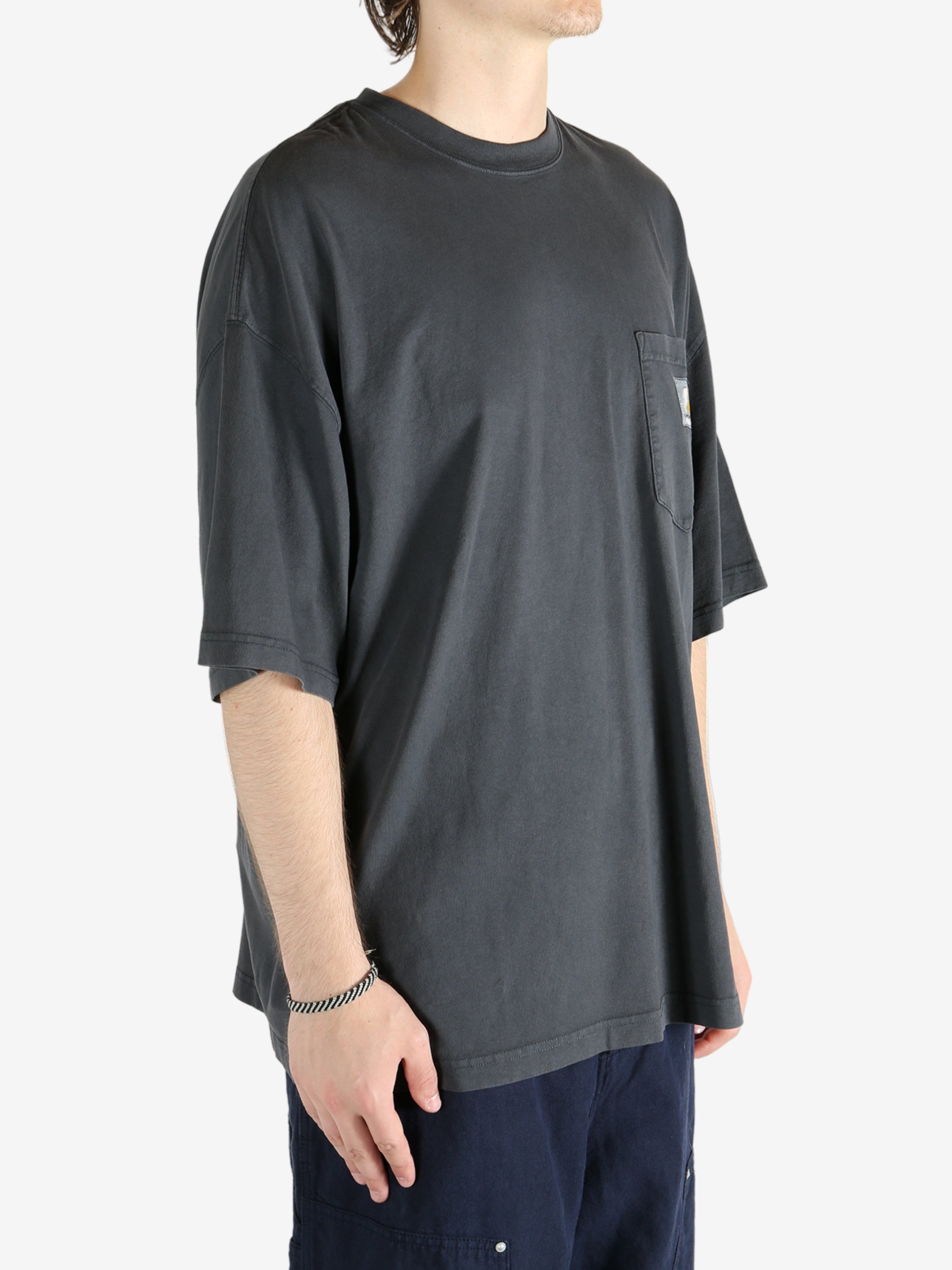Black t-shirt worn by a person, showing the t-shirt's fit