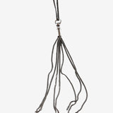 Close up of black necklace, showing texture of the silver fabric