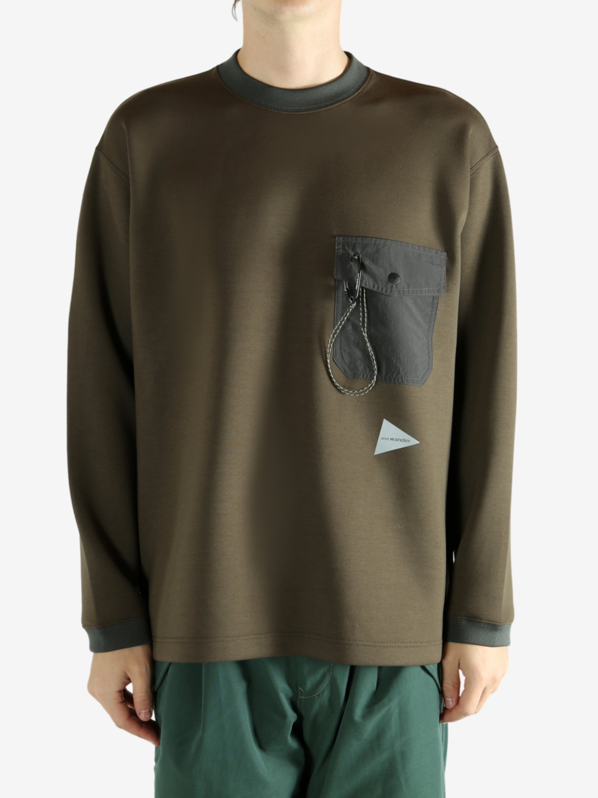 Brown pullover worn by a person, showing the pullover 's fit