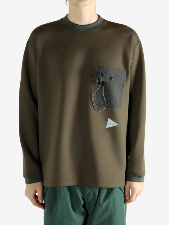 Brown pullover worn by a person, showing the pullover 's fit