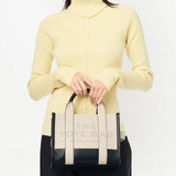 White bag worn by a person, showing the bag's fit