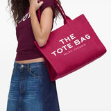 Pink bag, carried by a person, showing the bag's size