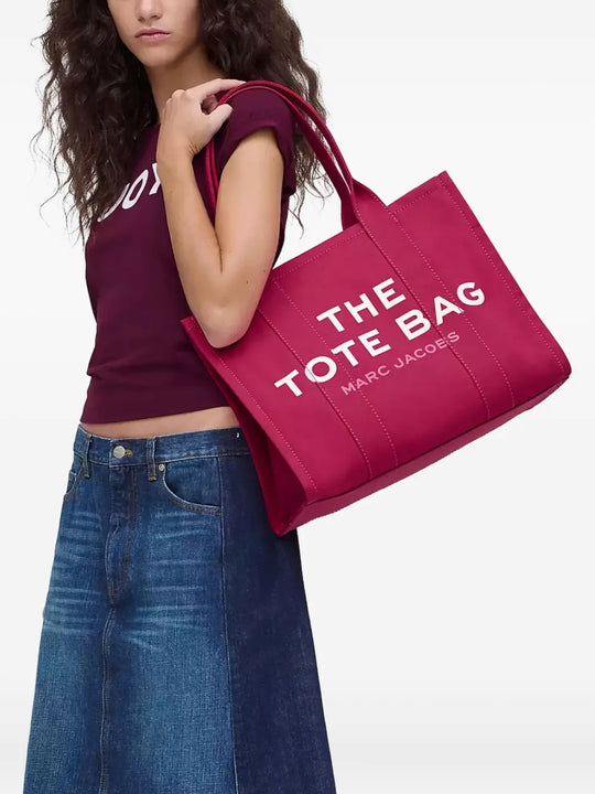 Pink bag, carried by a person, showing the bag's size