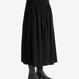 Black skirt worn by a person, showing the skirt fit