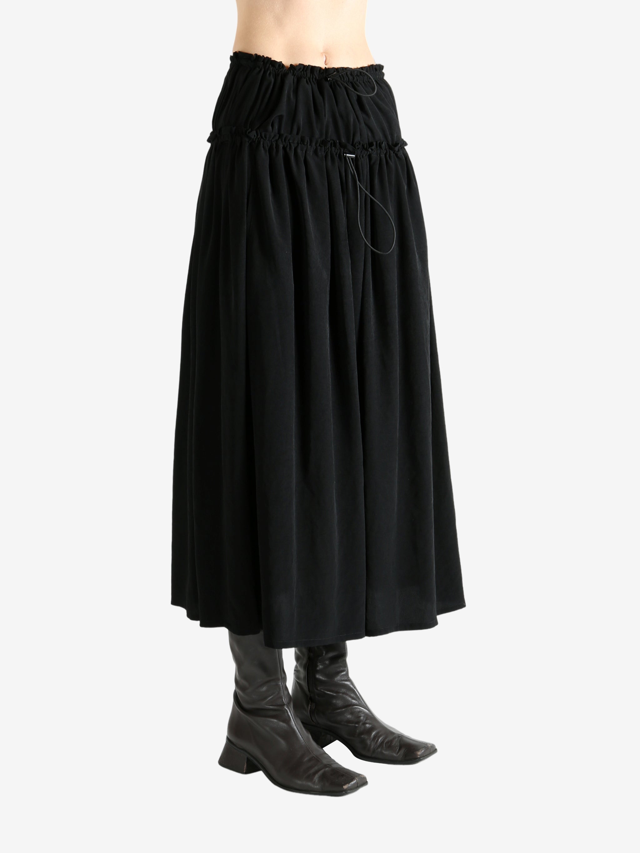 Black skirt worn by a person, showing the skirt fit
